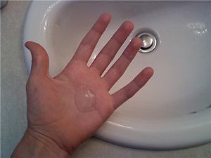 Liquid antibacterial soap on a person's hand.